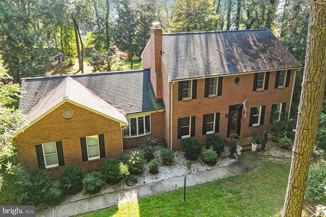 a aerial view of a house next to a yard