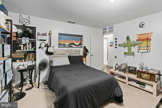 a bed room with a bed a television and a desk