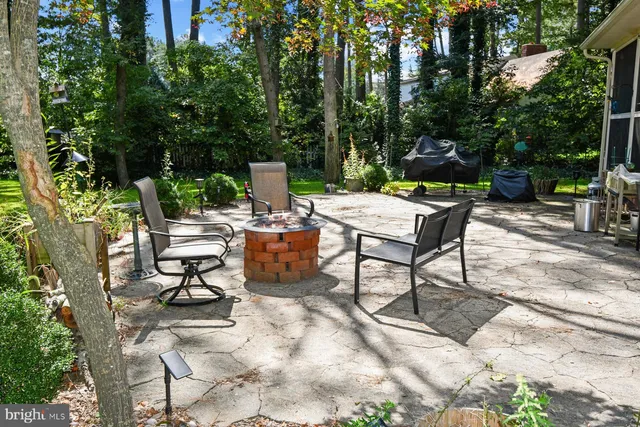 a view of a house with backyard sitting area and garden
