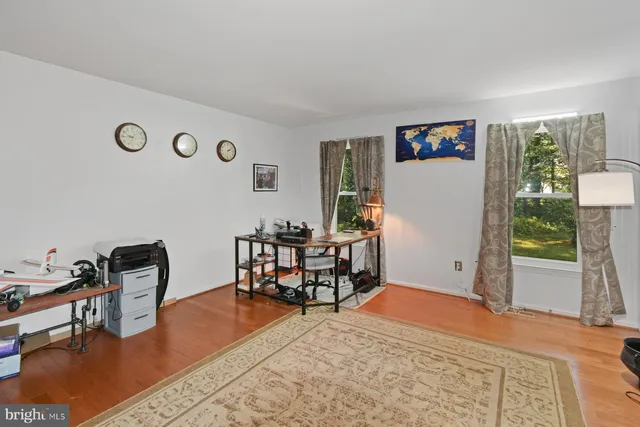 a workspace room with furniture and a window
