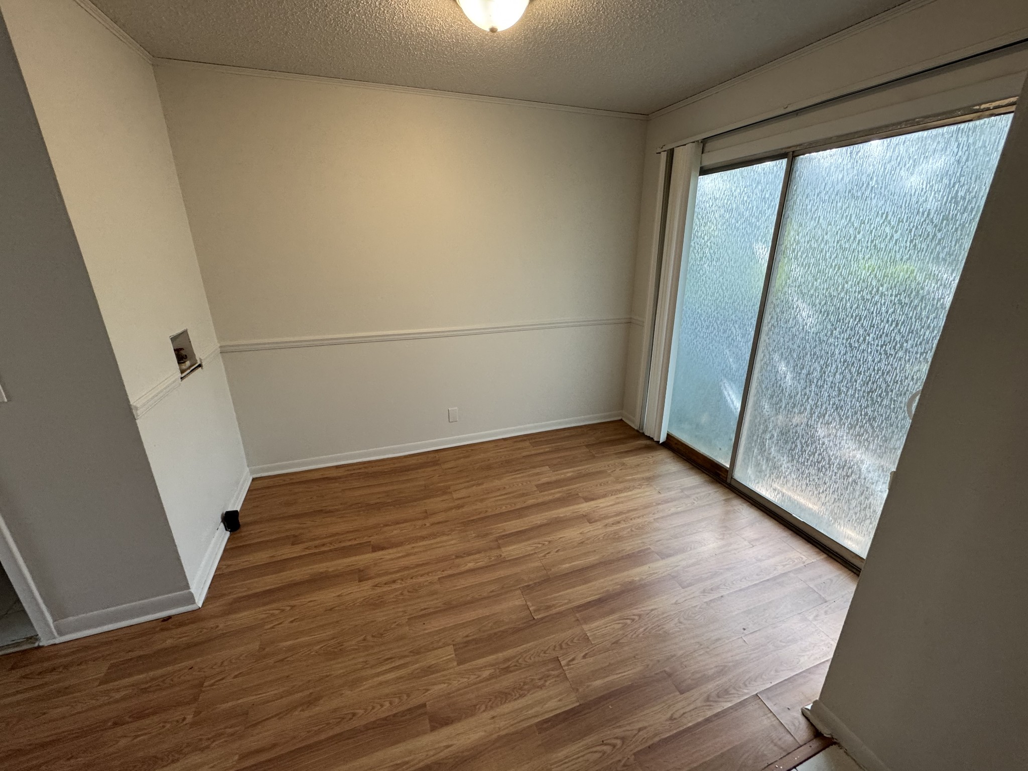 441 Harding Place, Unit C1 Nashville, TN 37211 - Photo 3 of 6 an empty room with wooden floor and door