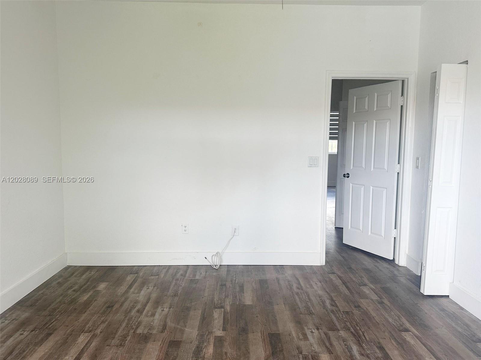 662 Northeast 21st Terrace Homestead, FL 33033 - Photo 14 of 34 an empty room with wooden floor and windows