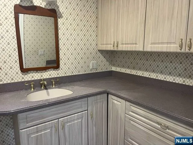 a bathroom with a sink and a mirror