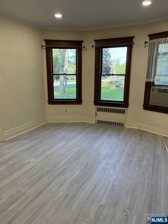 300 Harristown Road, Unit 1 Glen Rock, NJ 07452 - Photo 3 of 20 an empty room with wooden floor and windows
