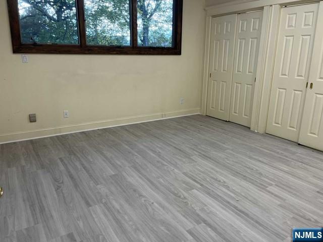 300 Harristown Road, Unit 1 Glen Rock, NJ 07452 - Photo 5 of 20 an empty room with wooden floor and windows