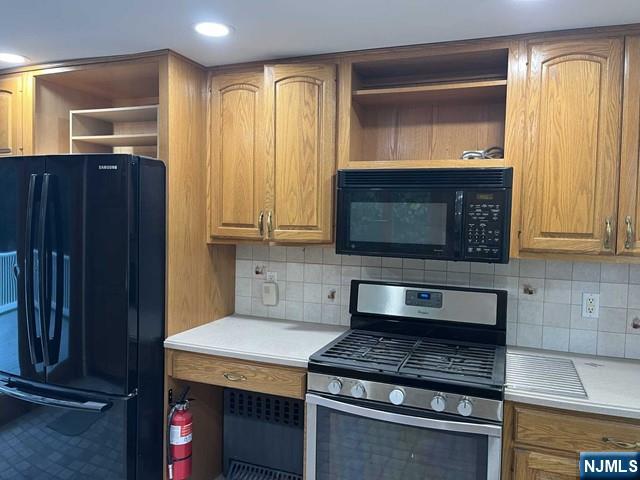 300 Harristown Road, Unit 1 Glen Rock, NJ 07452 - Photo 7 of 20 a kitchen with granite countertop a stove and a wooden cabinets