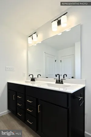 a bathroom with a double vanity sink and mirror