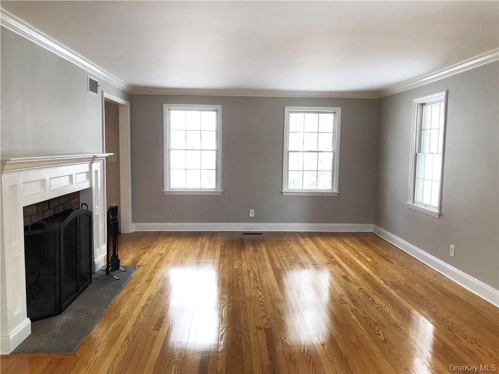 49 Commodore Road Chappaqua, NY 10514 - Photo 12 of 26 a view of an empty room with wooden floor fireplace and a window