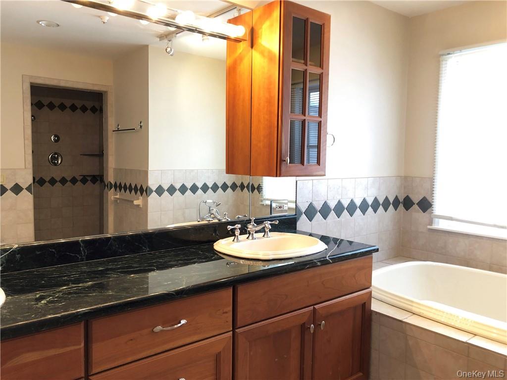 49 Commodore Road Chappaqua, NY 10514 - Photo 18 of 26 a bathroom with a granite countertop sink and a mirror