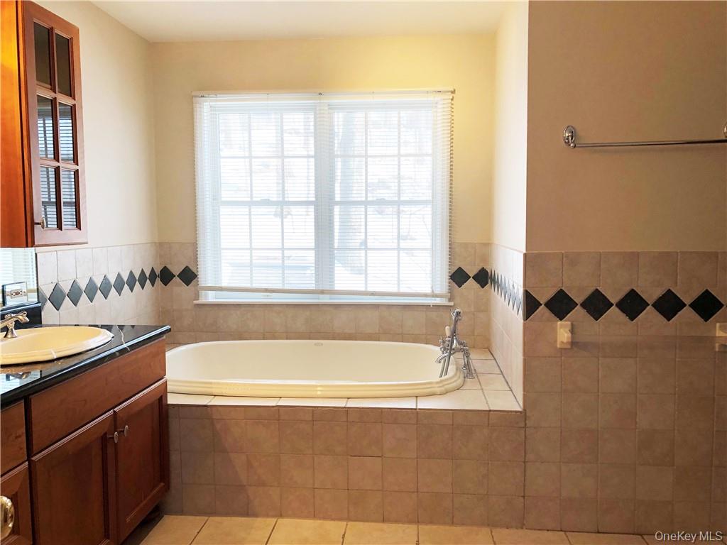 49 Commodore Road Chappaqua, NY 10514 - Photo 19 of 26 a bath tub sitting next to a window