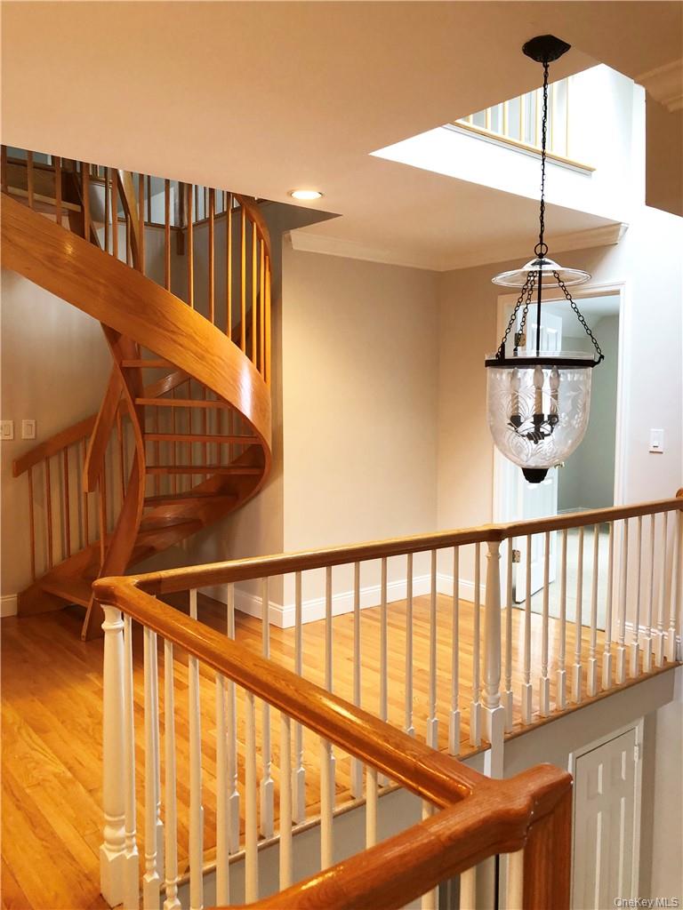 49 Commodore Road Chappaqua, NY 10514 - Photo 23 of 26 a view of staircase with railing and a chandelier