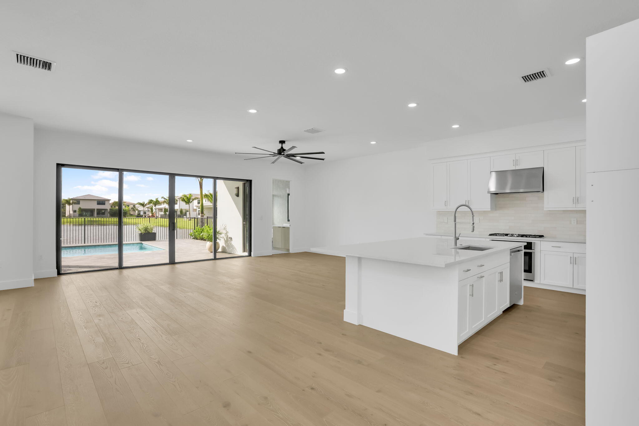 21049 Violet Flds Way Boca Raton, FL 33434 - Photo 9 of 54 a large white kitchen with a large window