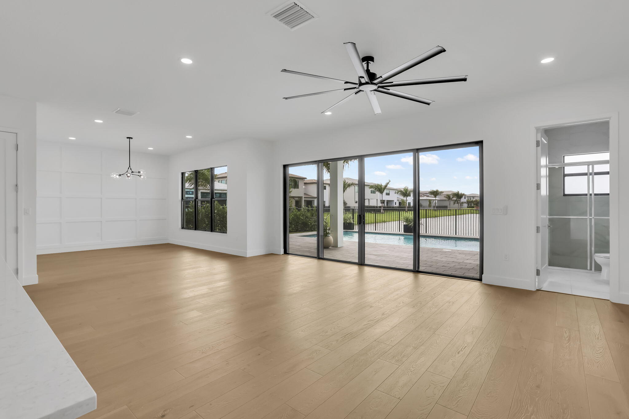 21049 Violet Flds Way Boca Raton, FL 33434 - Photo 10 of 54 a view of an empty room with a window and wooden floor