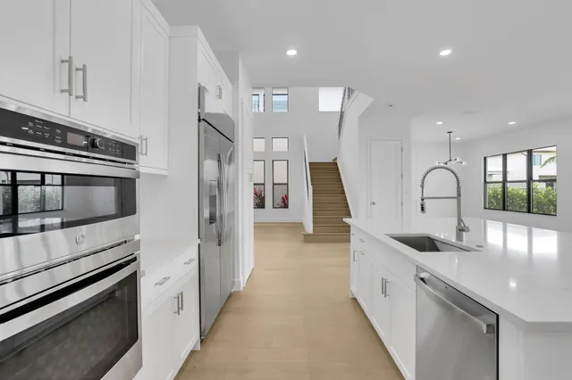a kitchen with stainless steel appliances granite countertop a sink and a stove