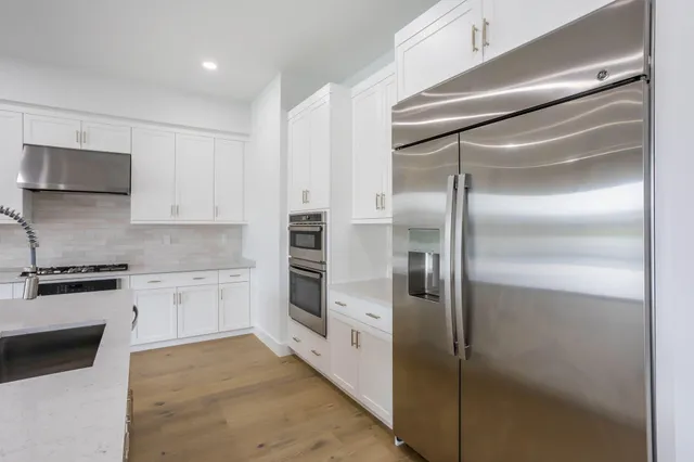 a kitchen with cabinets and stainless steel appliances