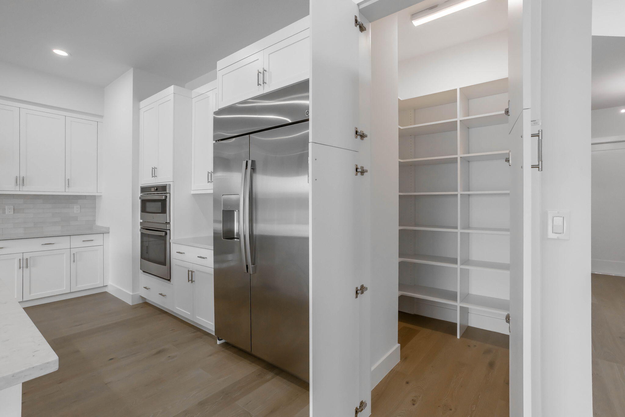 21049 Violet Flds Way Boca Raton, FL 33434 - Photo 16 of 54 a kitchen with a refrigerator and white cabinets