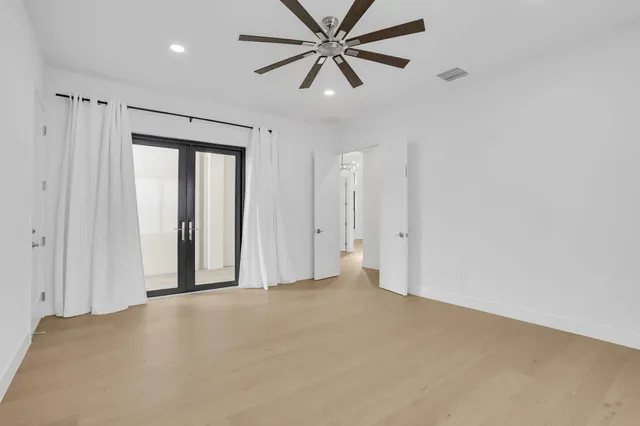 a view of a livingroom with a ceiling fan and window