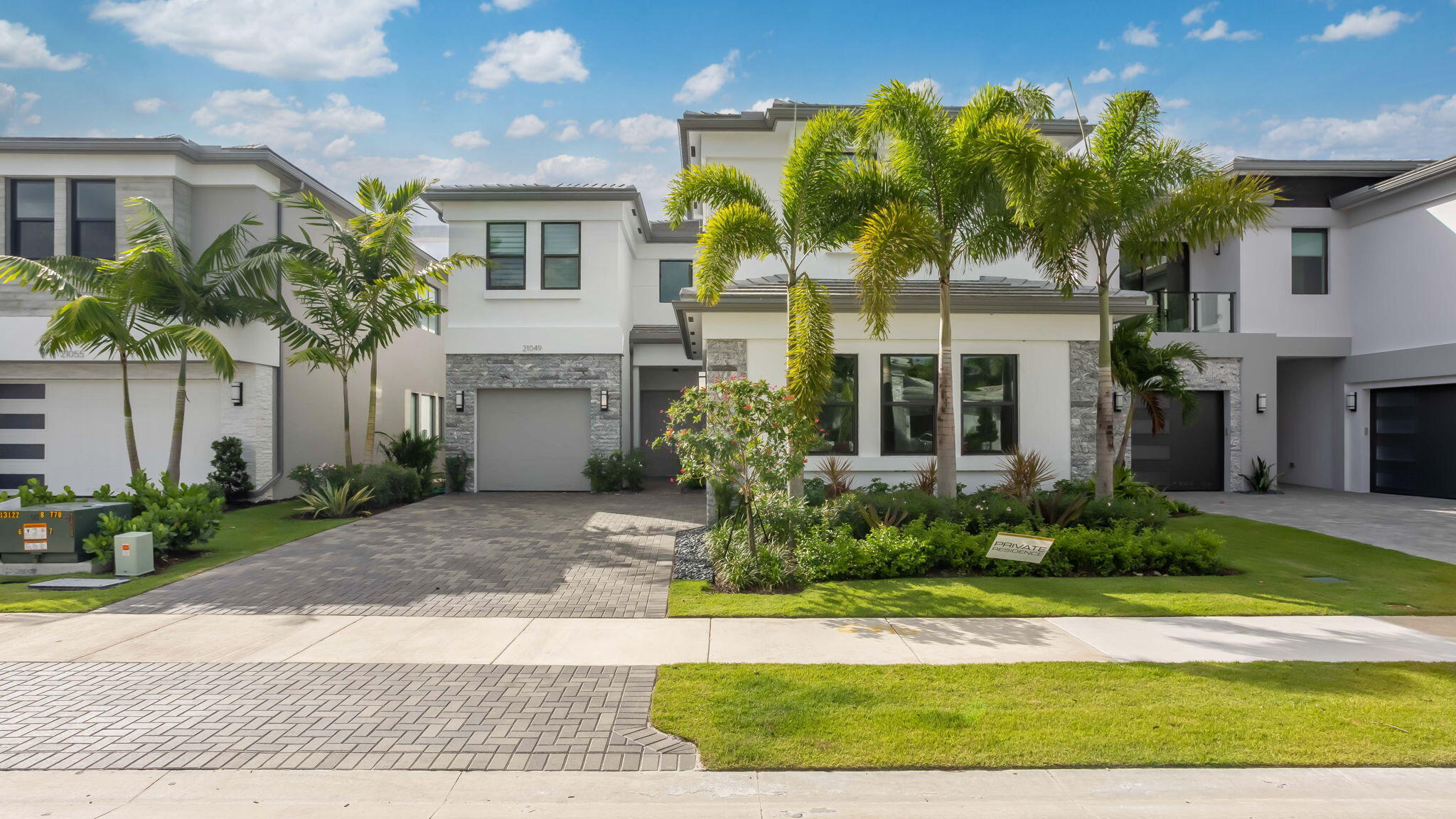 21049 Violet Flds Way Boca Raton, FL 33434 - Photo 2 of 54 a view of a white house with a yard and potted plants