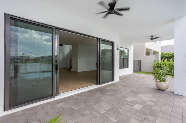 a view of an house with swimming pool and porch