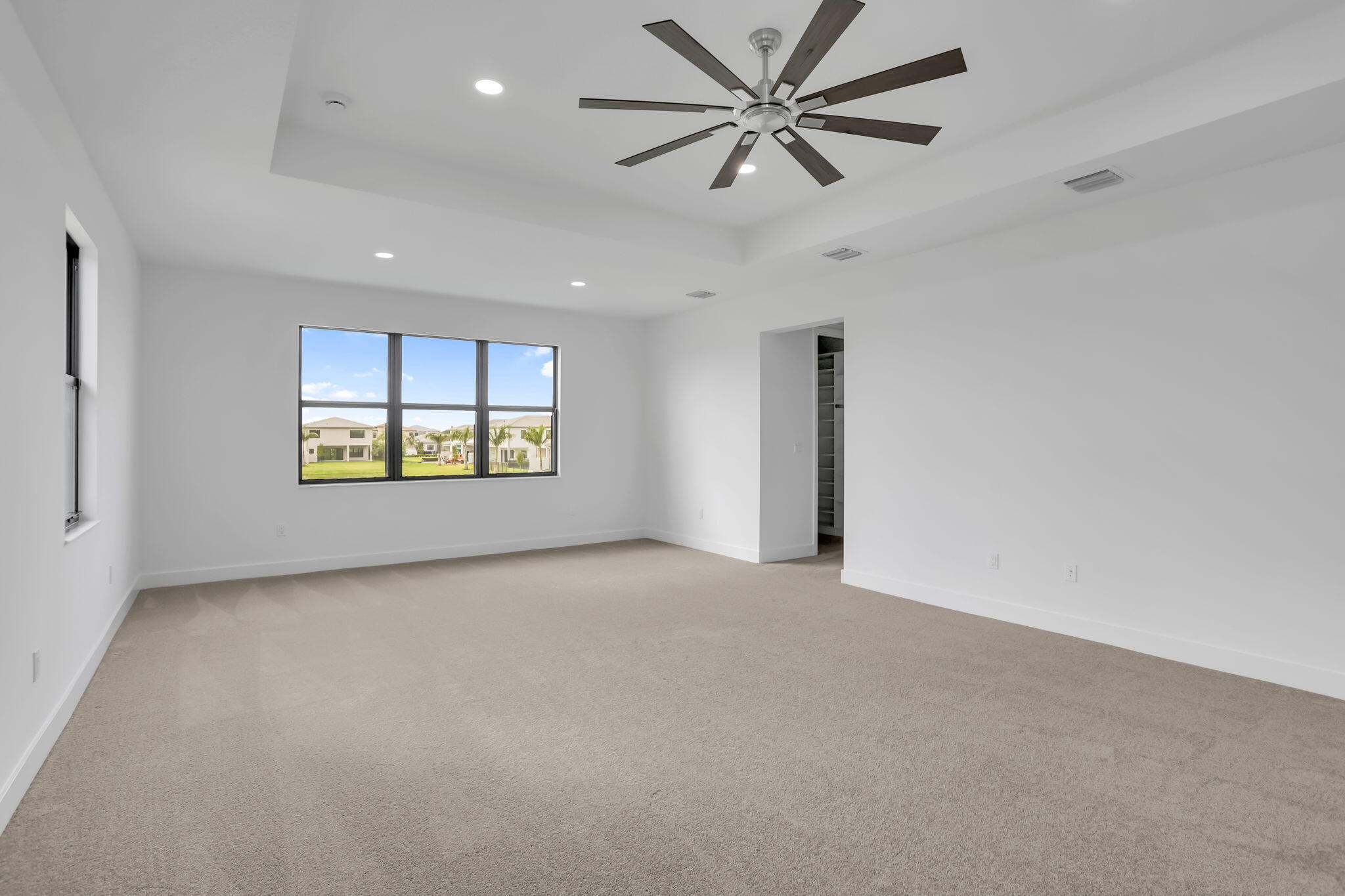 21049 Violet Flds Way Boca Raton, FL 33434 - Photo 28 of 54 an empty room with chandelier fan and windows