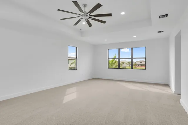 a view of an empty room with a ceiling fan