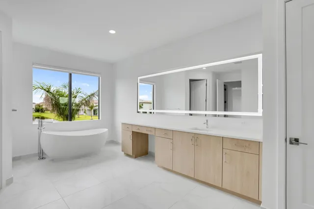 a view of an empty room with window and cabinet
