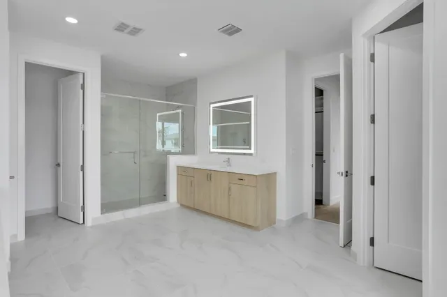 a living room with a large window and chandelier