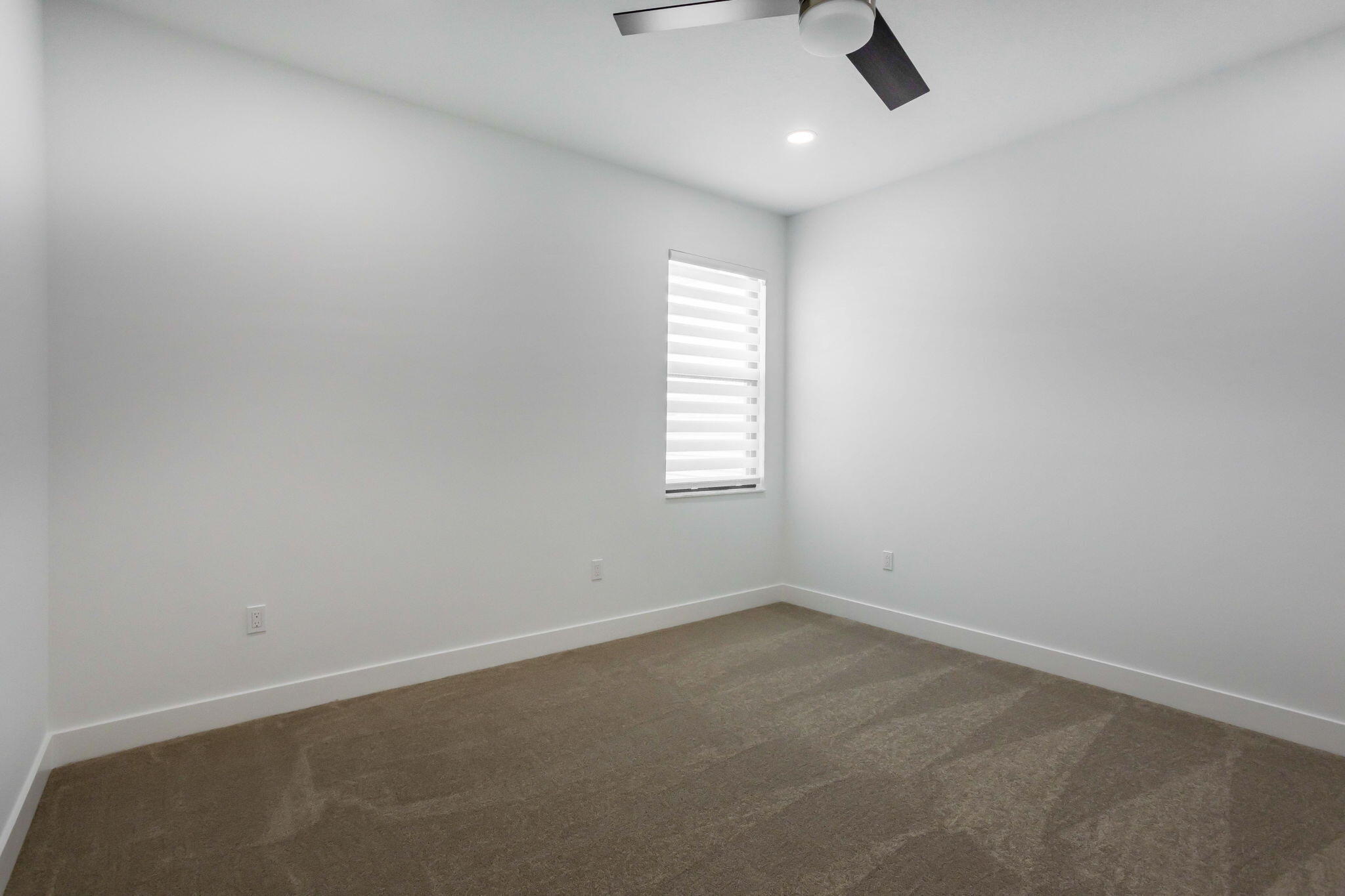 21049 Violet Flds Way Boca Raton, FL 33434 - Photo 37 of 54 an empty room with a window and ceiling fan