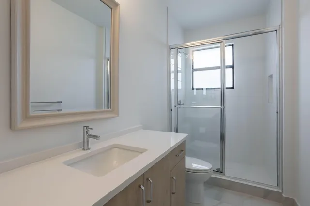 a bathroom with a sink toilet and shower