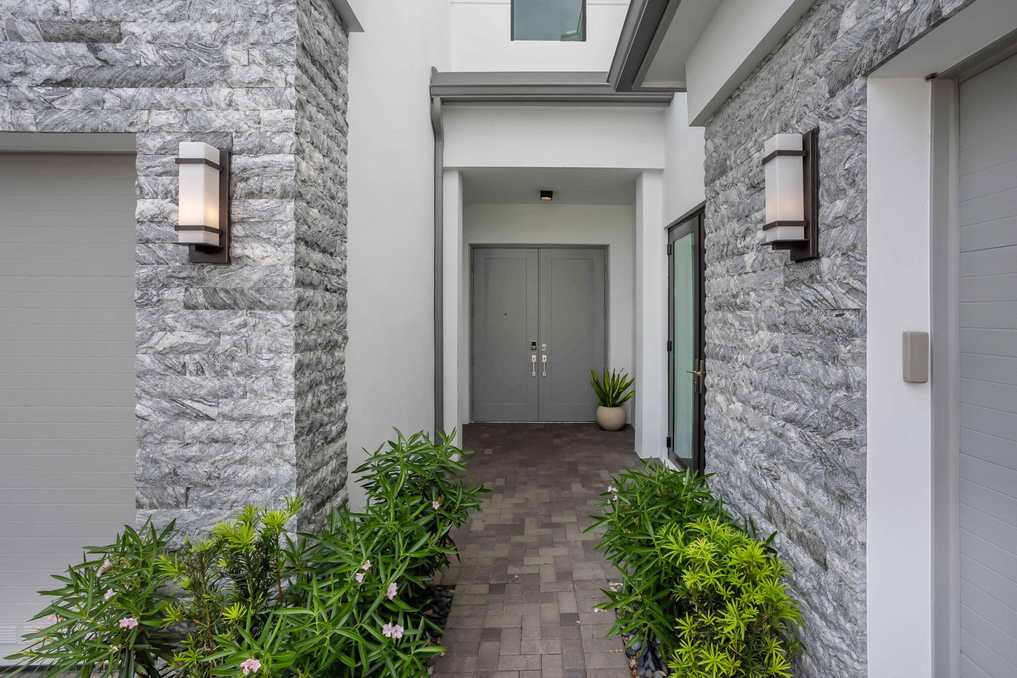 21049 Violet Flds Way Boca Raton, FL 33434 - Photo 3 of 54 a view of a brick house with potted plants