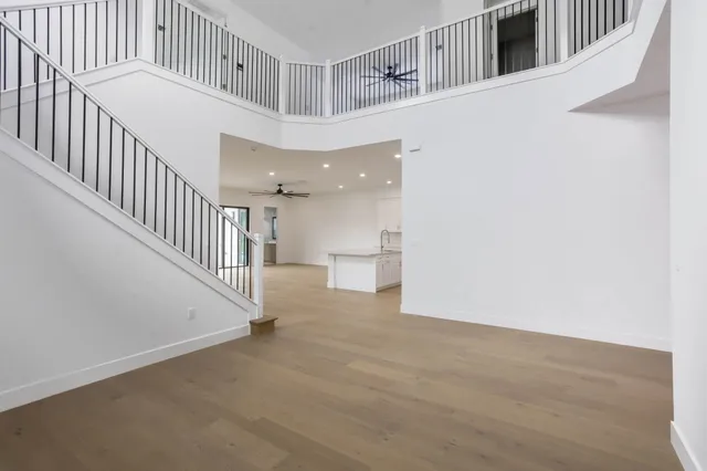 a view of entryway and hall with wooden floor