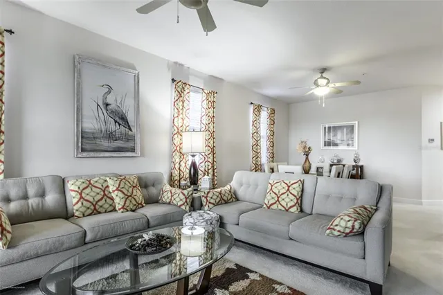 a living room with furniture kitchen view and a table