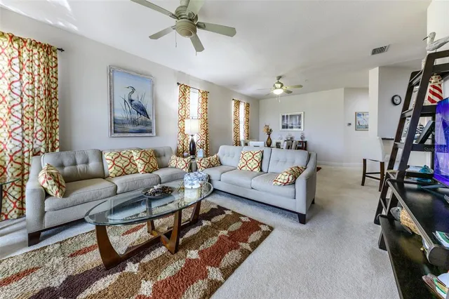 a living room with furniture a rug and a flat screen tv