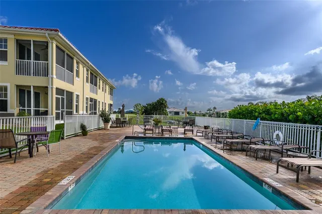 a view of swimming pool with outdoor seating