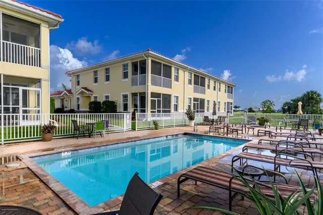 a view of a patio with couches chairs and wooden floor