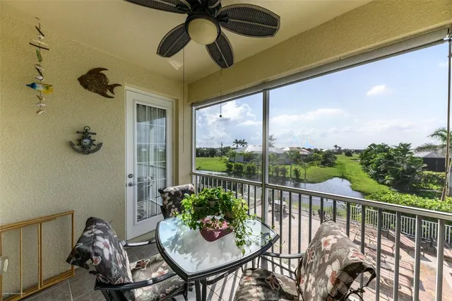 a view of a balcony with chairs potted plants