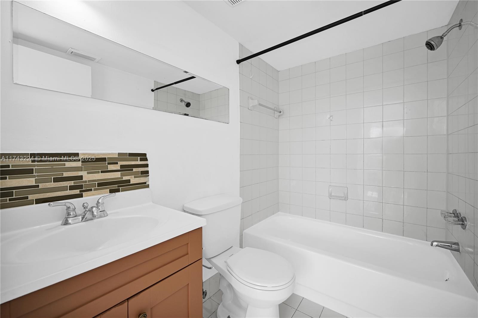 2575 Southwest 27th Avenue, Unit 508 Miami, FL 33133 - Photo 14 of 15 a bathroom with a sink a toilet and a bathtub