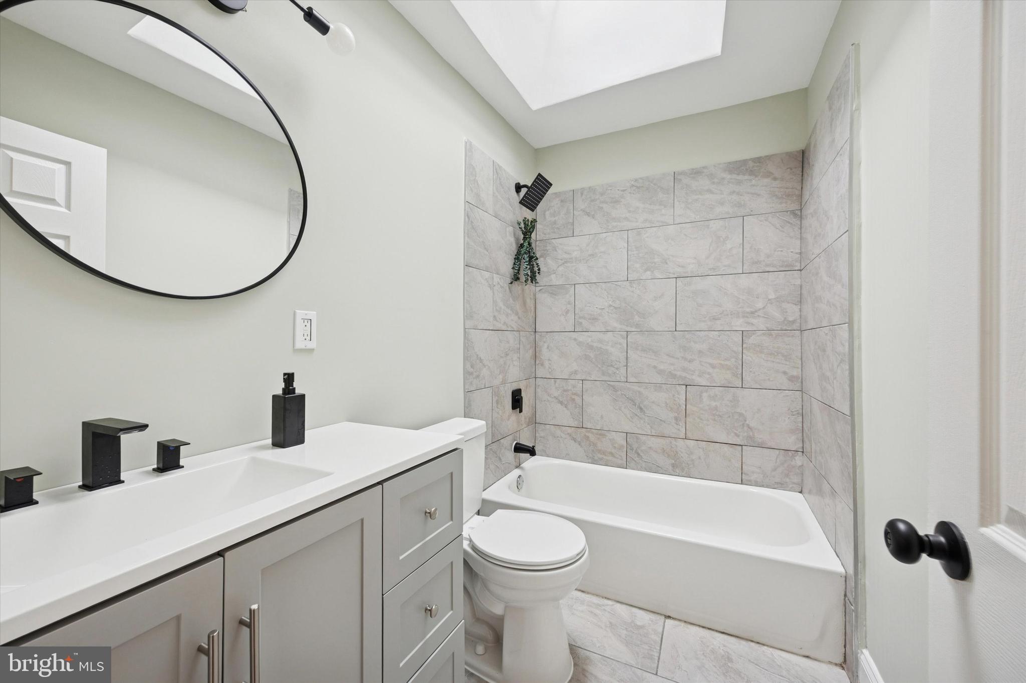 7046 Radbourne Road Upper Darby, PA 19082 - Photo 12 of 14 a bathroom with a sink a toilet and a mirror
