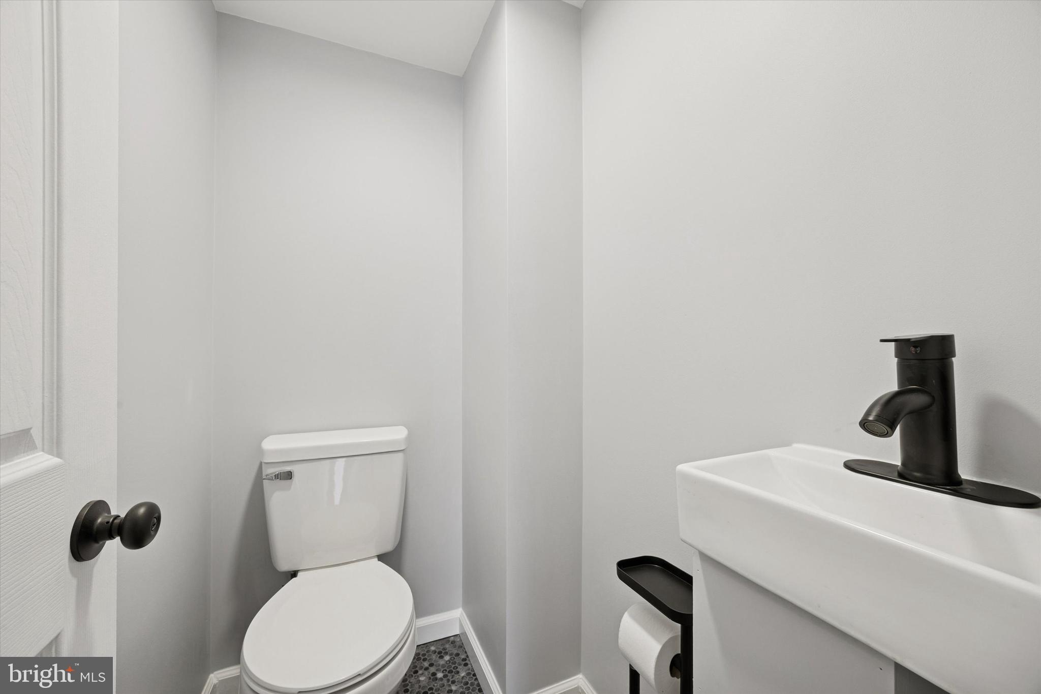 7046 Radbourne Road Upper Darby, PA 19082 - Photo 7 of 14 a bathroom with a toilet a sink and mirror
