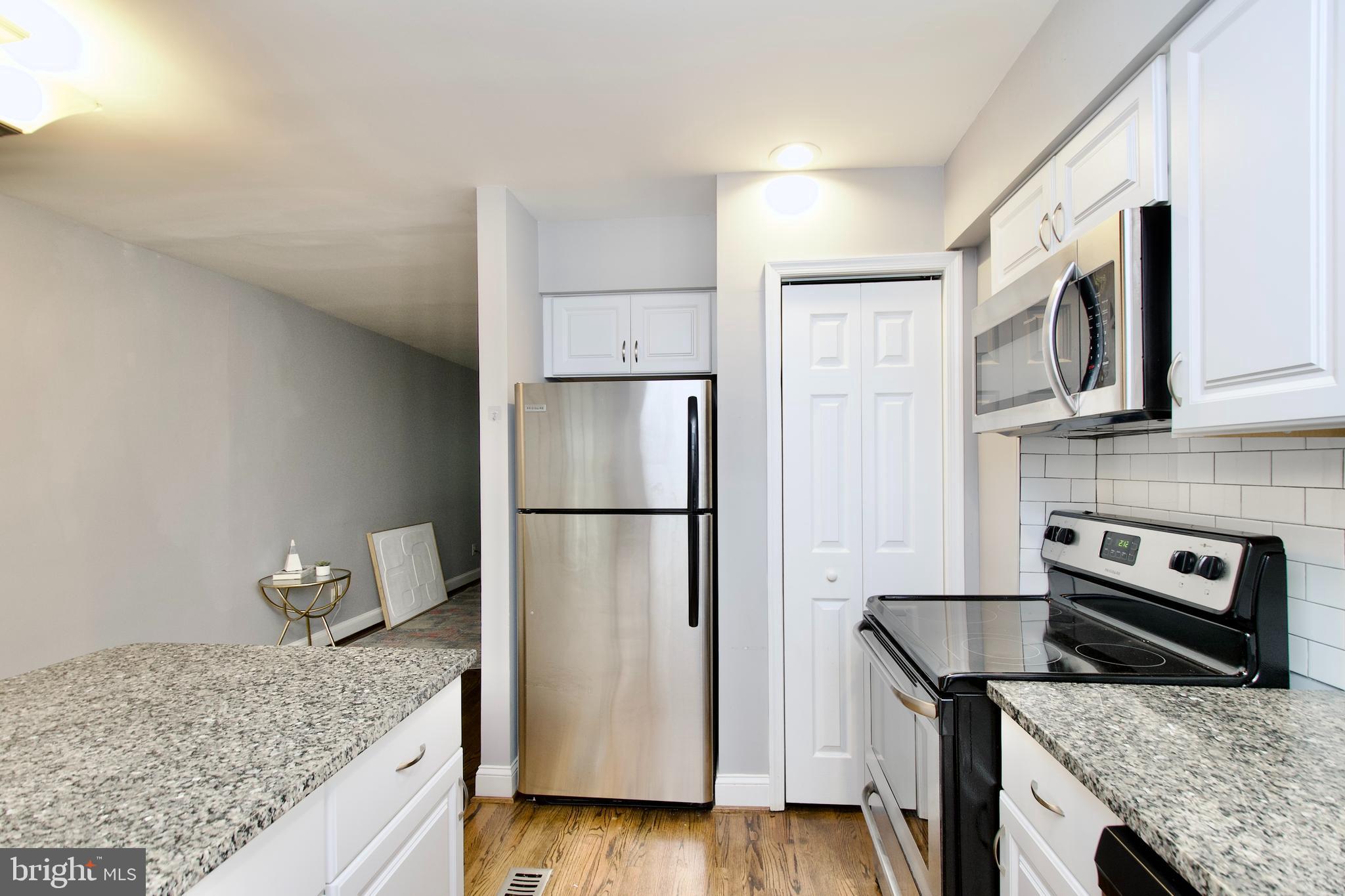 1365 Talbert Terrace Southeast Washington, DC 20020 - Photo 11 of 29 a kitchen with stainless steel appliances granite countertop a refrigerator a stove and a sink