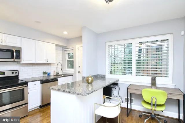 a kitchen with a table chairs stove and microwave