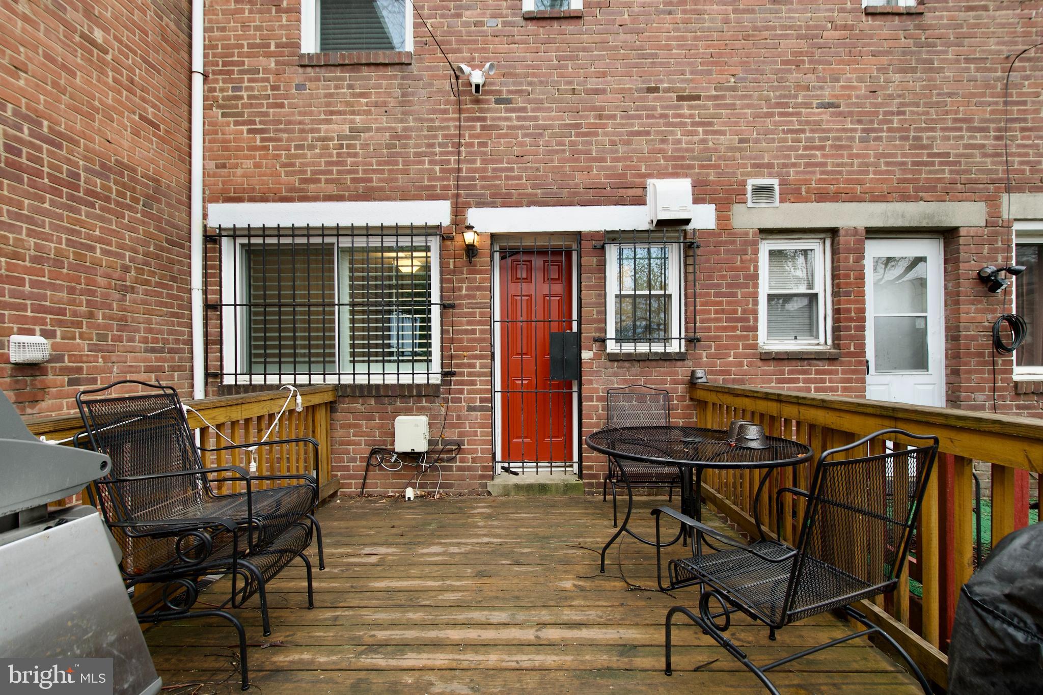 1365 Talbert Terrace Southeast Washington, DC 20020 - Photo 21 of 29 a view of a brick building with a bench in patio