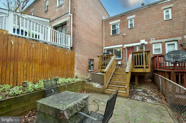 a view of a chair and table in the backyard