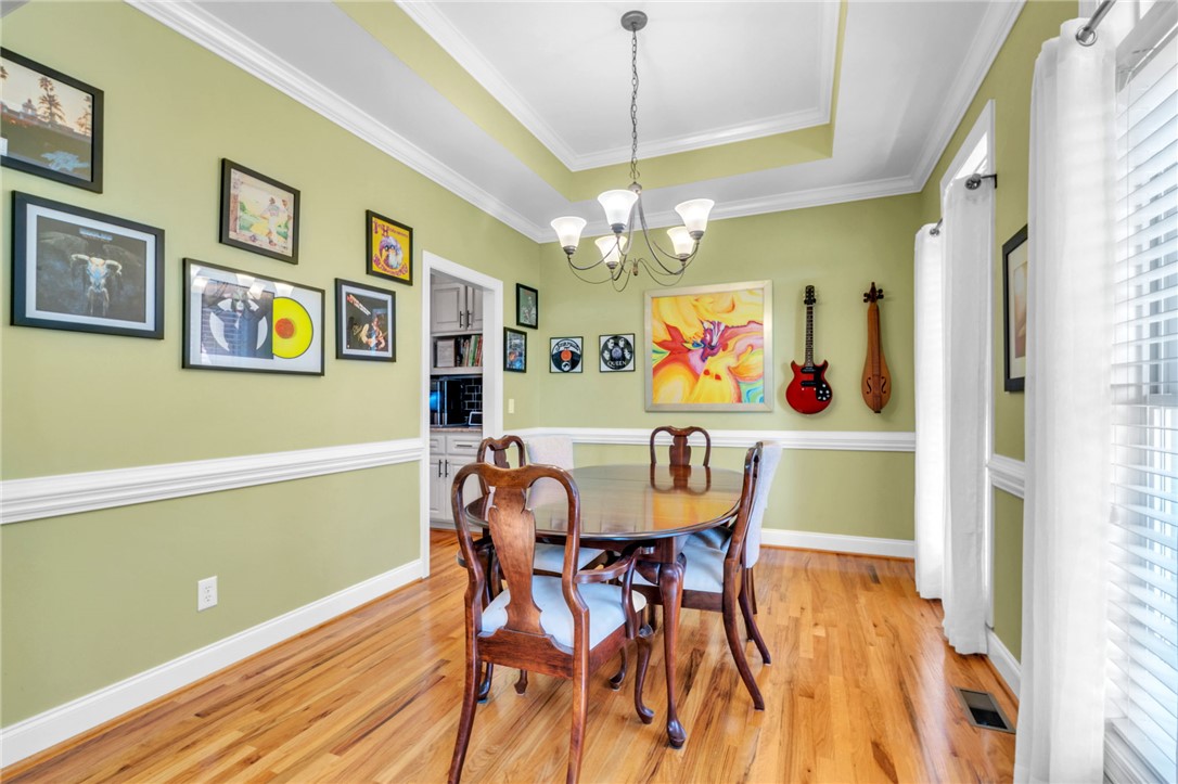 648 Mountain View Road Williamston, SC 29697 - Photo 7 of 42 A classic dining room features crown molding, a tray ceiling, and gleaming hardwood floors.