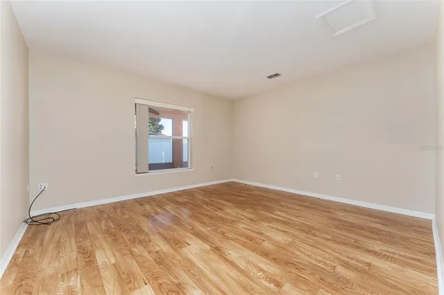wooden floor in an empty room with a window