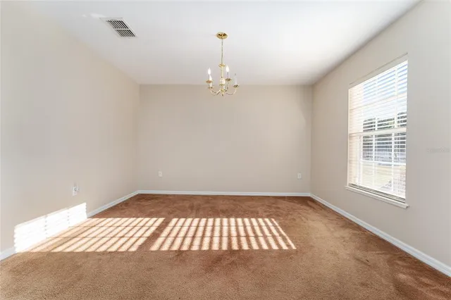 a view of a livingroom with wooden floor and a ceiling fan