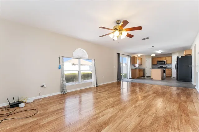 a kitchen with sink cabinets and wooden floor