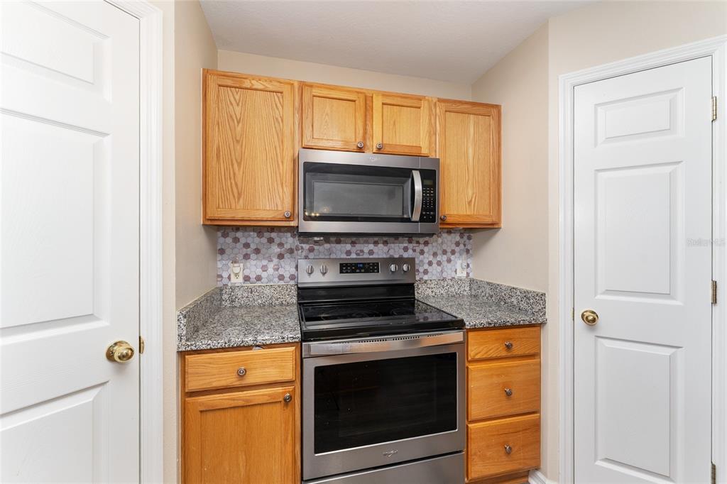 2661 Northeast 42nd Road Ocala, FL 34470 - Photo 33 of 74 a kitchen with a stove and a microwave