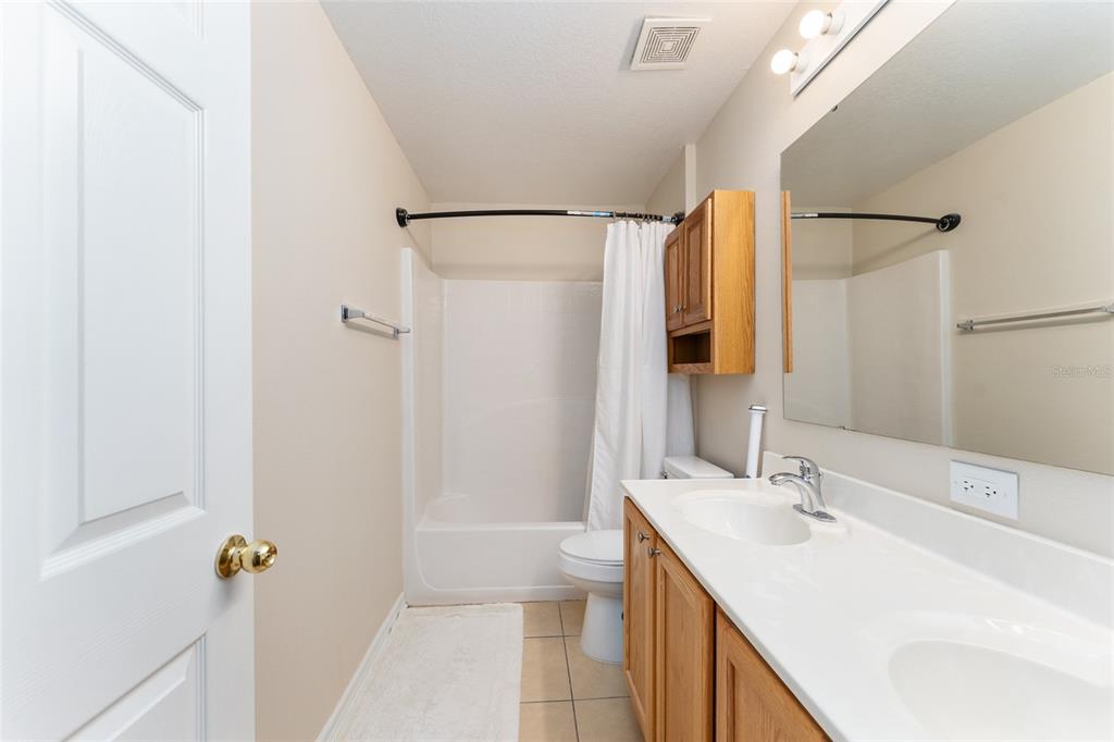 2661 Northeast 42nd Road Ocala, FL 34470 - Photo 43 of 74 a bathroom with a sink and mirror with toilet