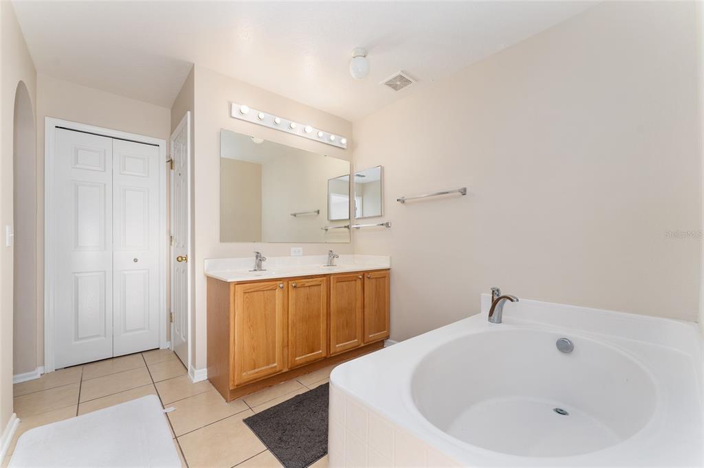 2661 Northeast 42nd Road Ocala, FL 34470 - Photo 50 of 74 a spacious bathroom with a bathtub sink and mirror